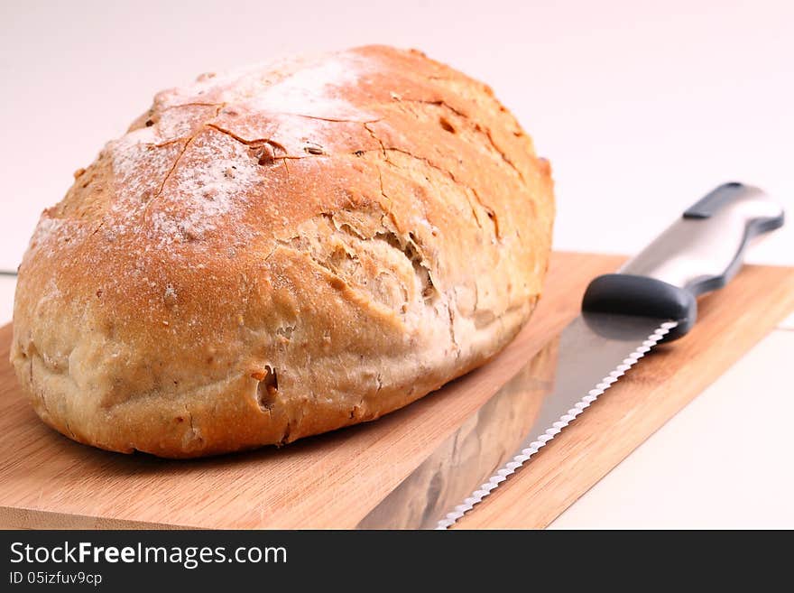 Loaf of bread and knife on a cutting board