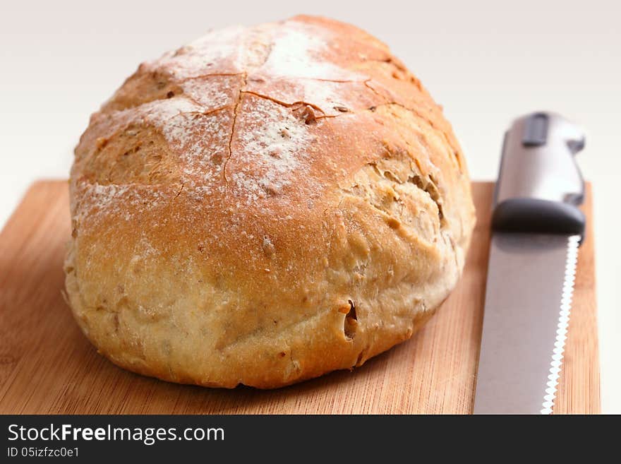 Loaf of bread and knife on a cutting board