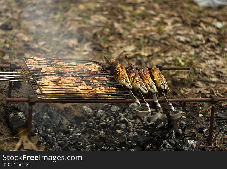 In wood grilled chicken and fried mackerel fish is very tasty and appetizing smells barbeque