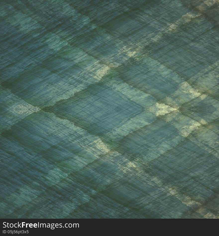 A diamond shaped plaid pattern created by layering pictures of the ocean waves and blending to create a textured pattern of greens and blues. A diamond shaped plaid pattern created by layering pictures of the ocean waves and blending to create a textured pattern of greens and blues.