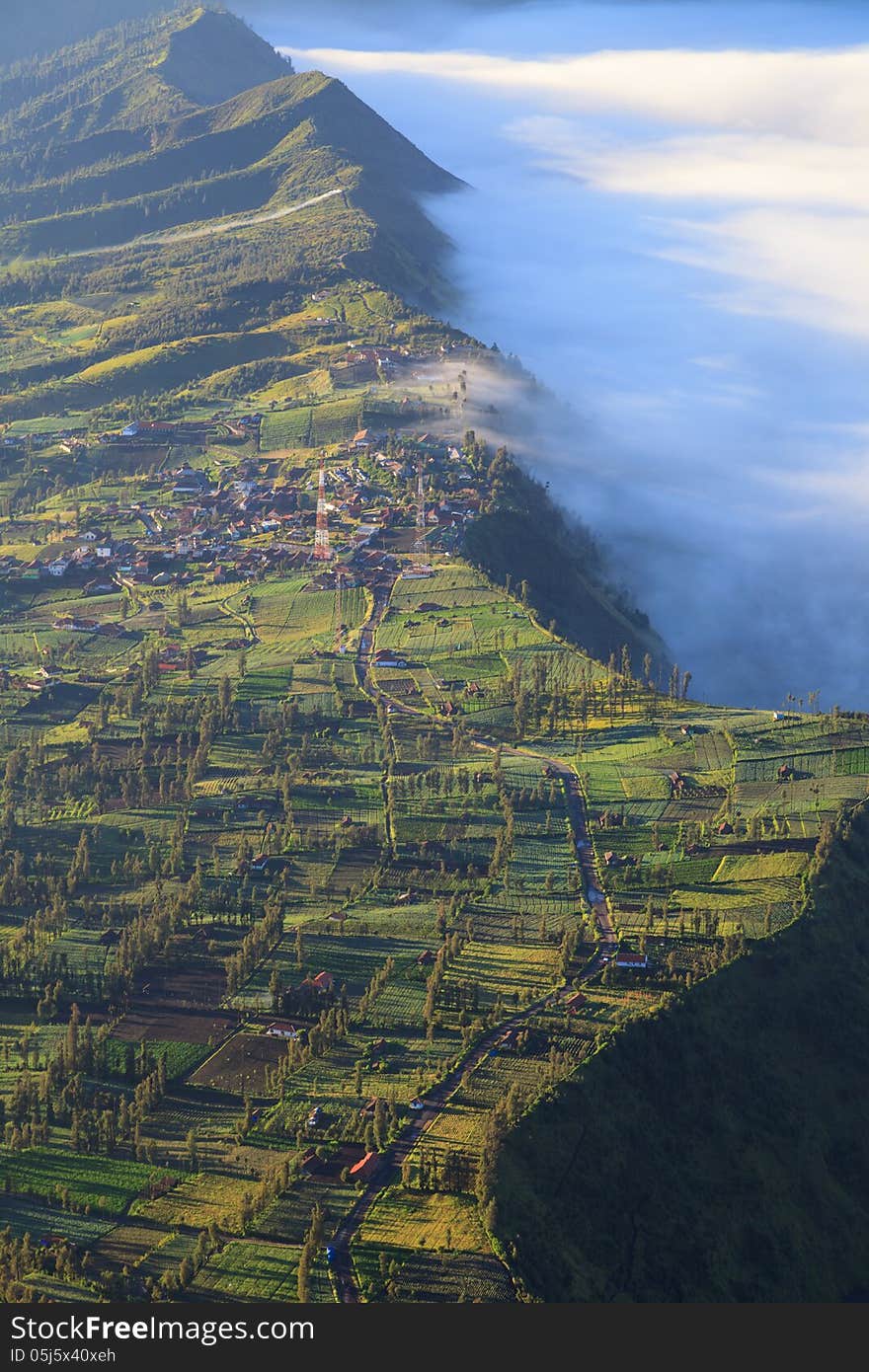 Village and Cliff at Bromo Volcano Mountain in Tengger Semeru National Park at sunrise, East Java, Indonesia