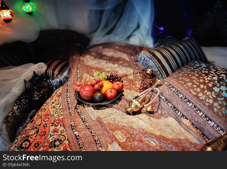 Still life in the Oriental style, on the carpets, fruit plate and a hookah. Still life in the Oriental style, on the carpets, fruit plate and a hookah