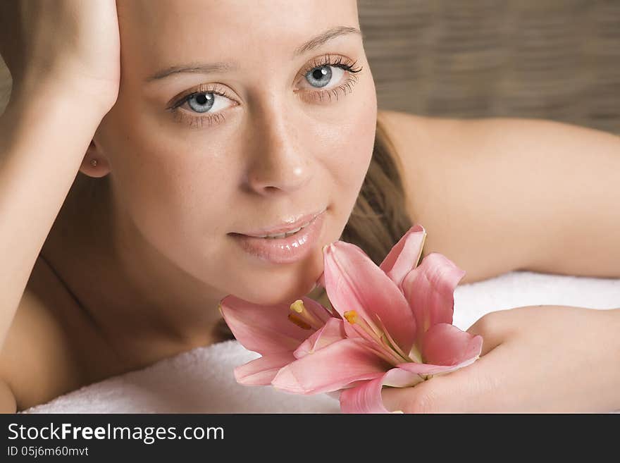 Beauty woman with flower getting spa treatment