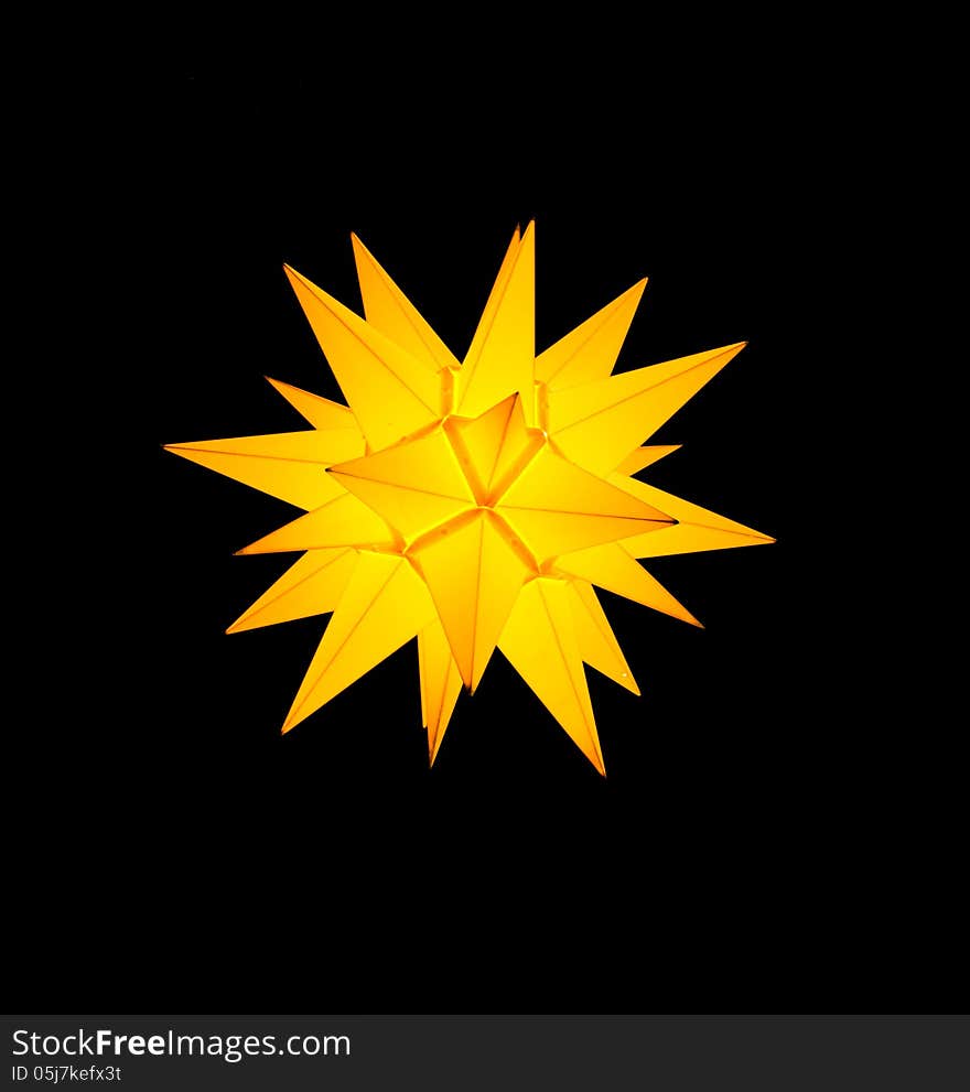 Bright yellow lit lampion on black background. Bright yellow lit lampion on black background