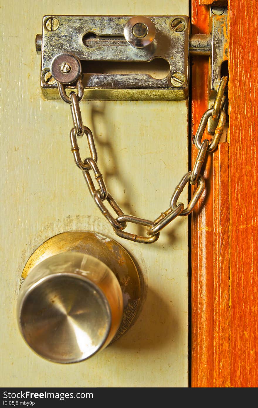 Rusty metal chains with the door.