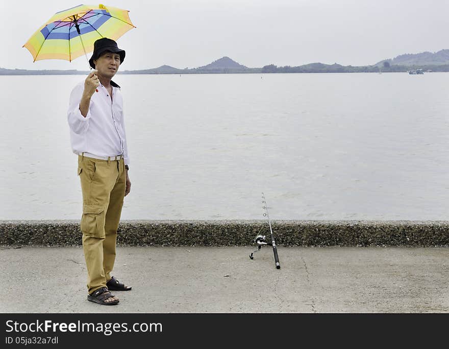 Senior fisherman catches a fish in the sea