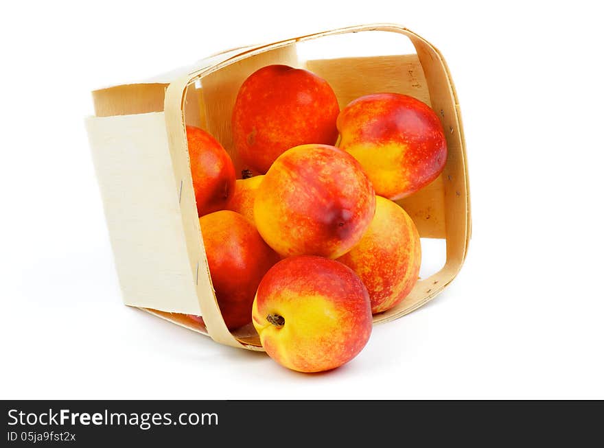 Heap of Perfect Ripe Nectarines Scattered of Basket closeup isolated on white background