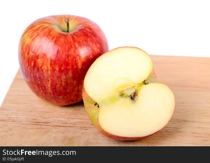 One and a half apple on wood cutting board