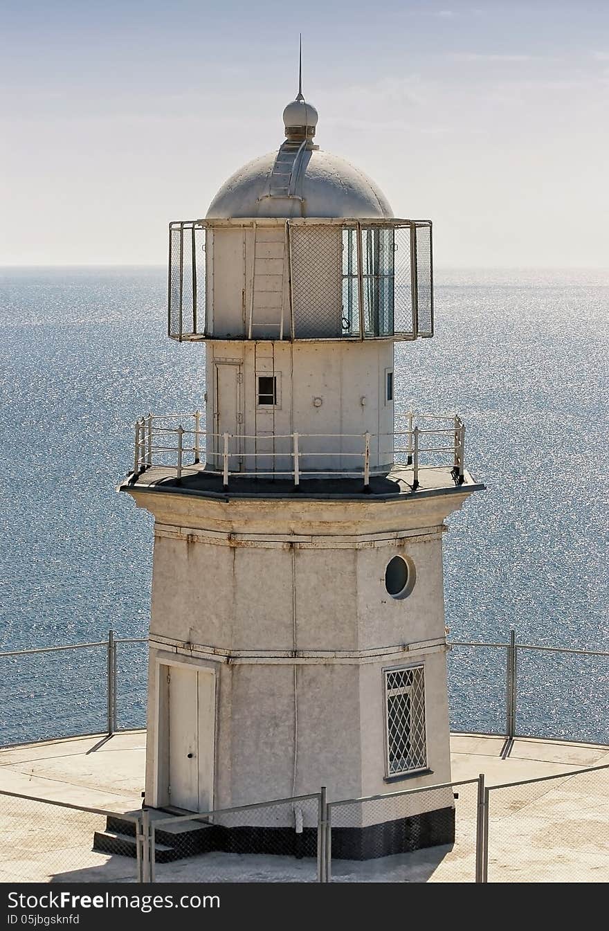 Close up of white lighthouse on sea background