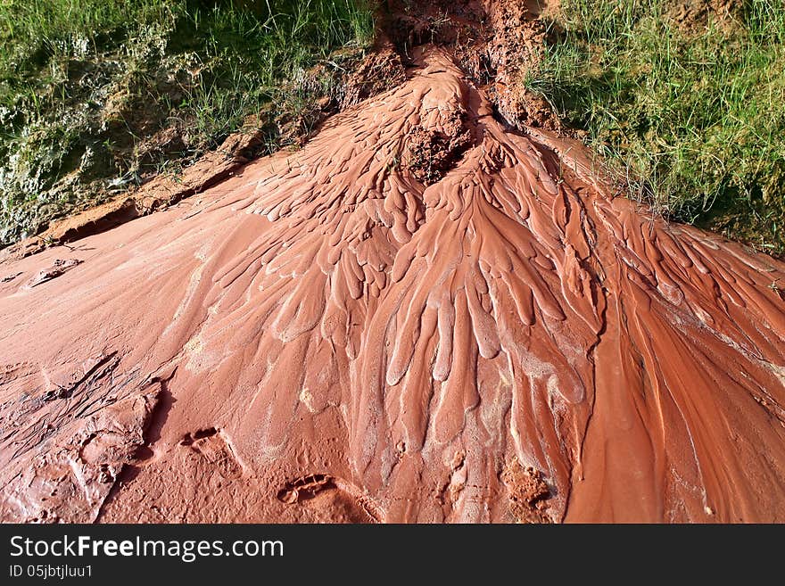 Wet red sand. Water has etched a pattern into sand. Ham Tien canyon in Vietnam