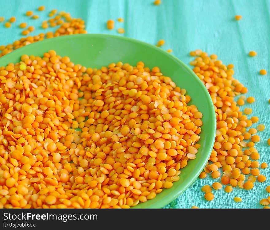 Red lentils on the green background