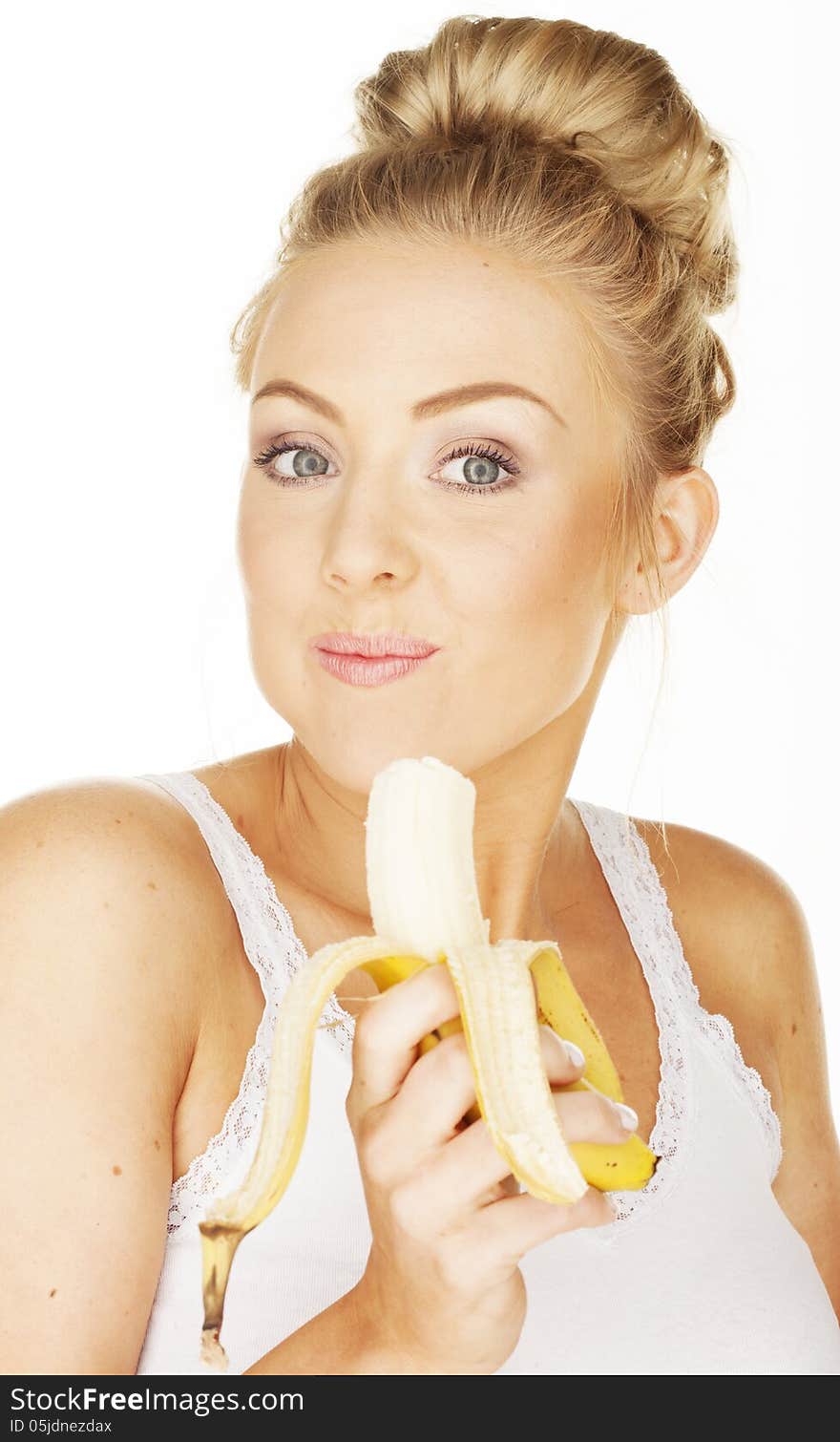 Cute blonde girl eating banana. Cute blonde girl eating banana