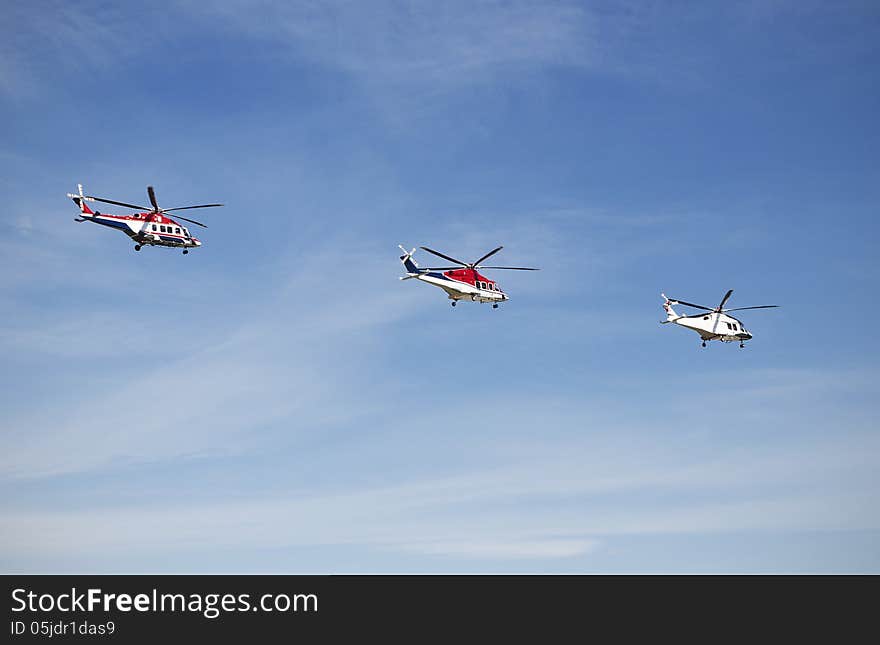 Three helicopters in the sky