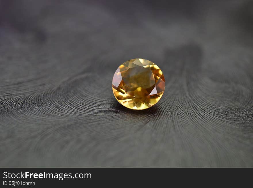 A shiny orange gem isolated on a black background