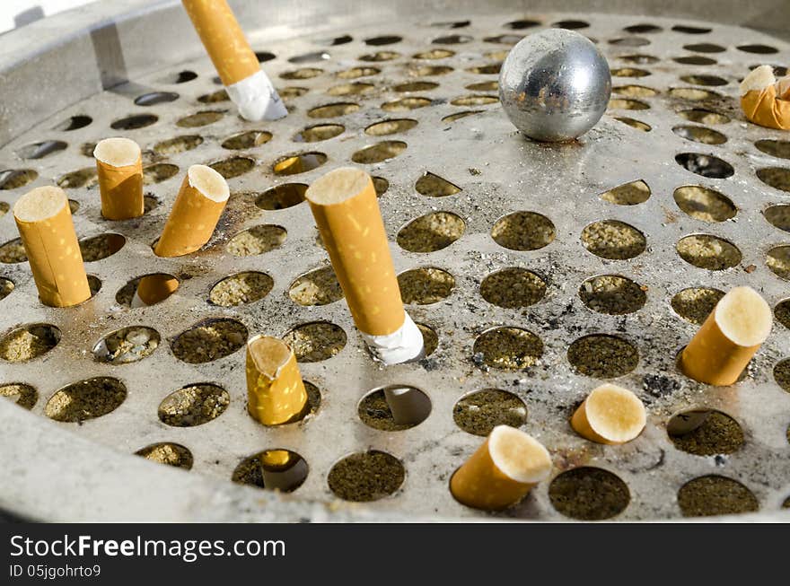 Cigarette in aluminium bin close up. Cigarette in aluminium bin close up