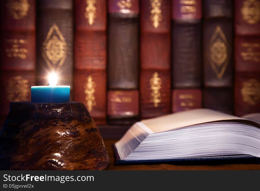 Antiquity - reading old books with candle light