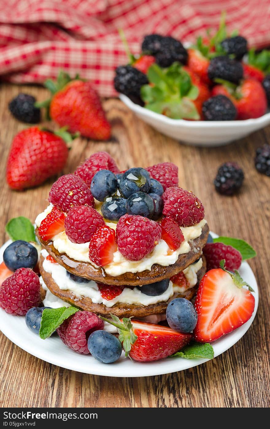 Pancakes with whipped cream and fresh berries