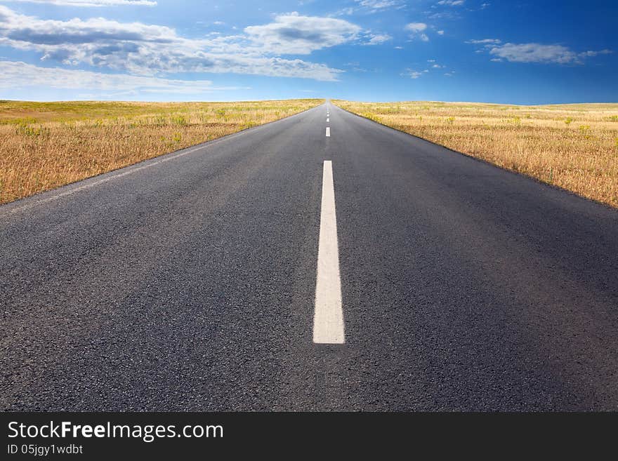 Driving on an empty road at bright sunlight