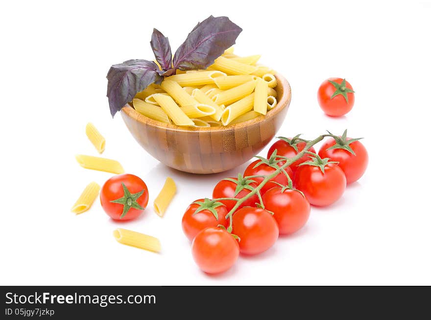 Penne pasta, fresh tomatoes and basil isolated