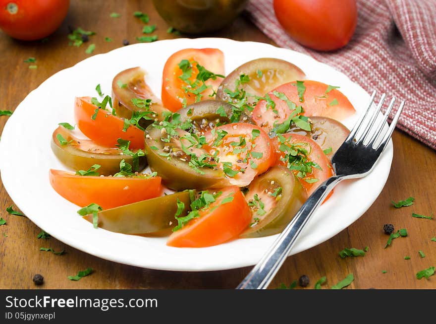 Salad of two varieties of tomatoes with fresh parsley horizontal