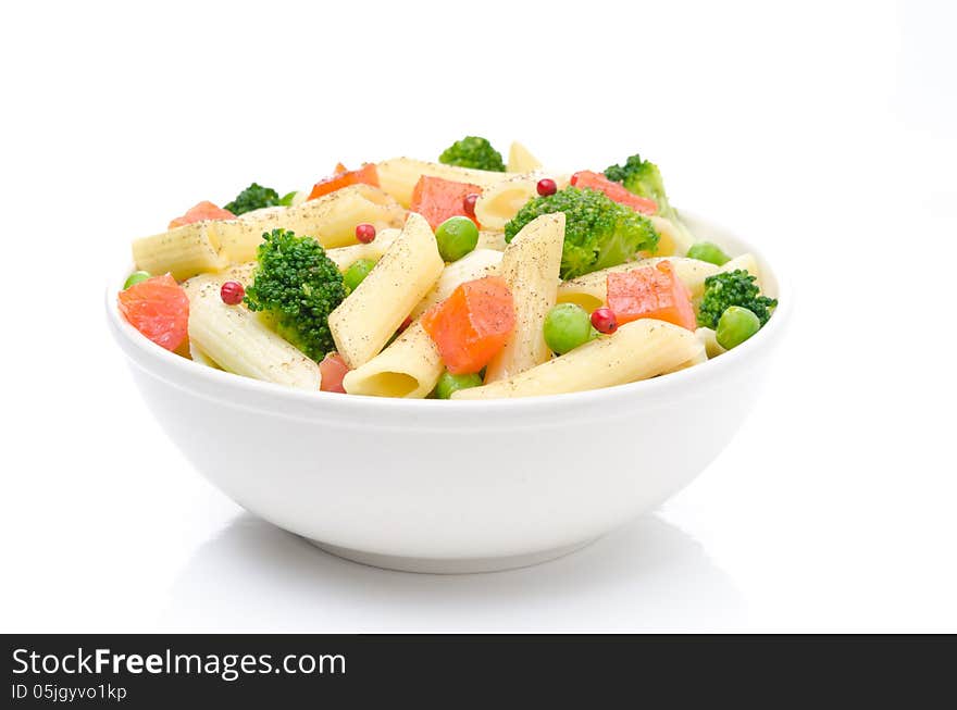 Salad with pasta, smoked salmon, broccoli and green peas in a bowl on a white background. Salad with pasta, smoked salmon, broccoli and green peas in a bowl on a white background