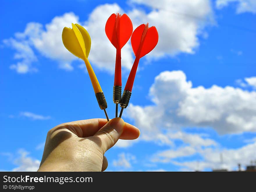 three arrows darts in hand on celestial background