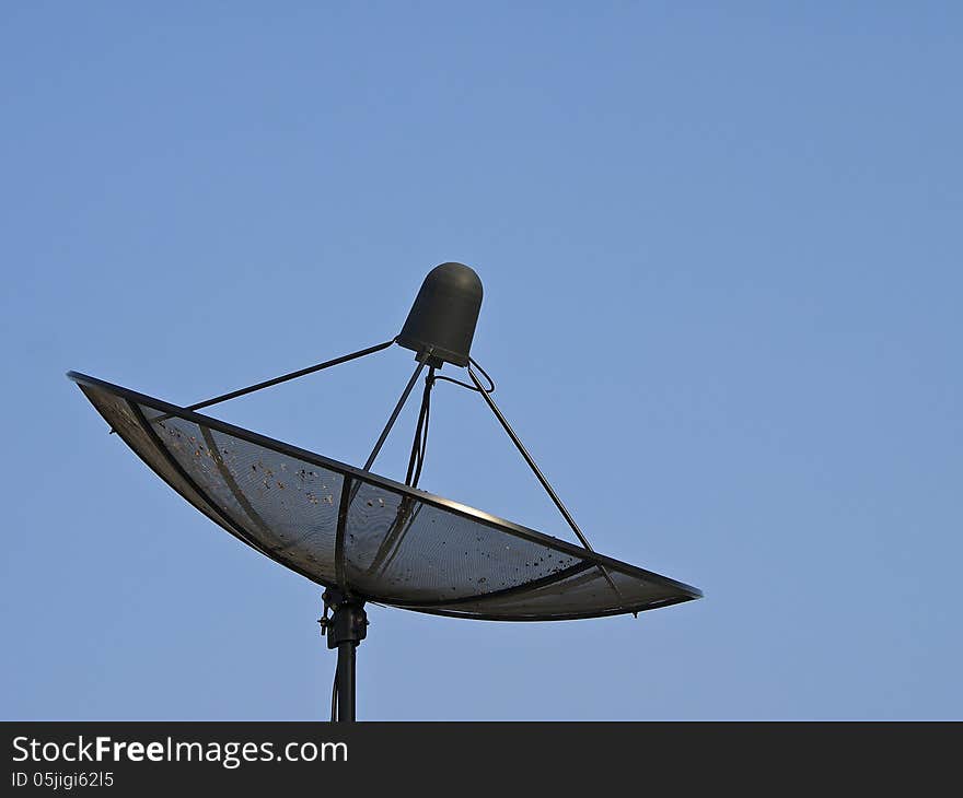 Black satellite dish in blue sky and sunlight. Black satellite dish in blue sky and sunlight