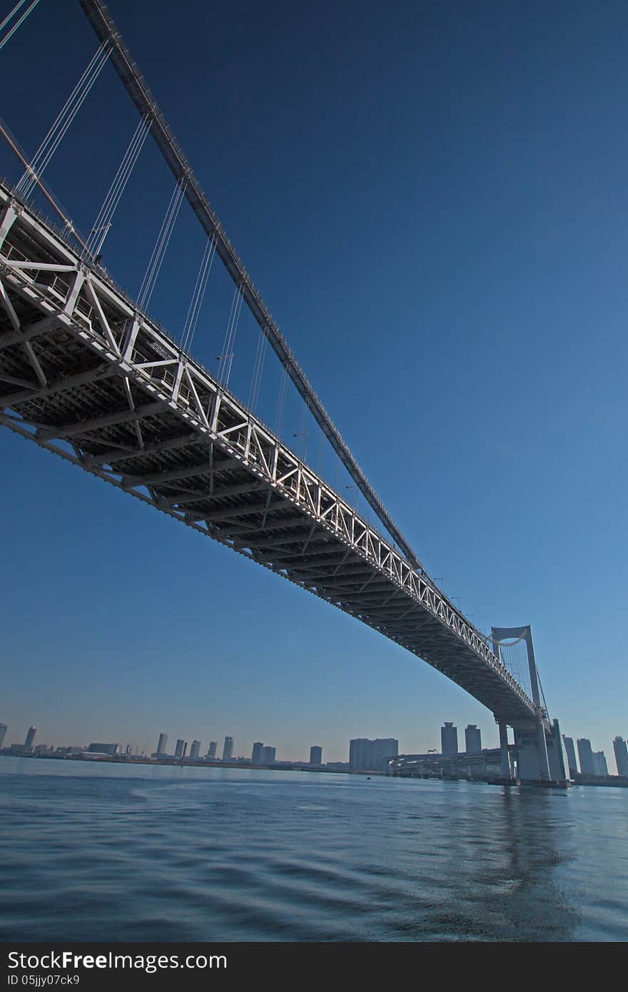 A bridge hanging over Tokyo Bay is photographed by the bottom. The name of this bridge is Ranbow bridge. A bridge hanging over Tokyo Bay is photographed by the bottom. The name of this bridge is Ranbow bridge.