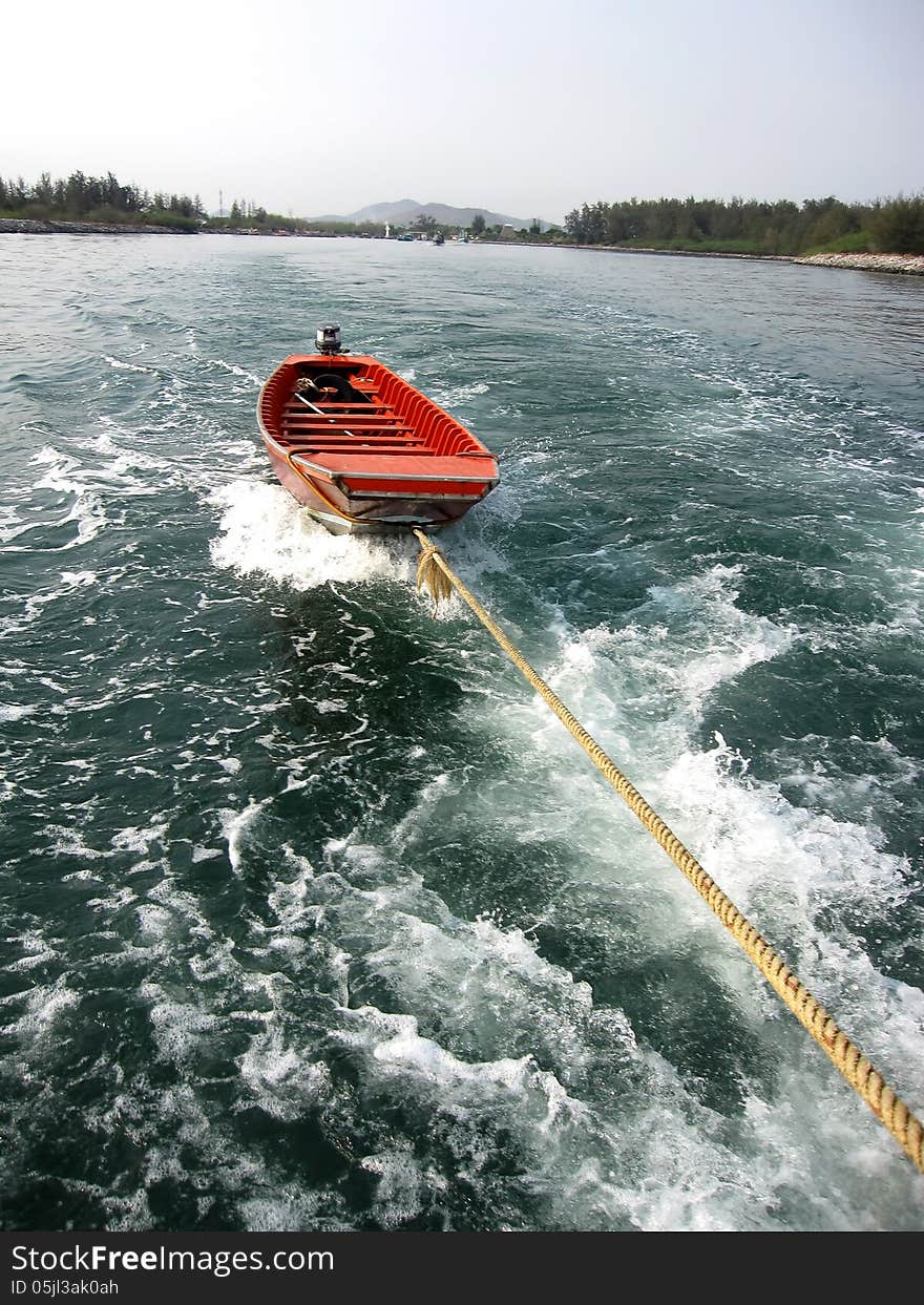 Small boat in sea with landscape background