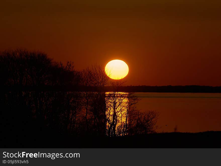 Beautiful sunset above the sea taken with an extreme telephoto lens