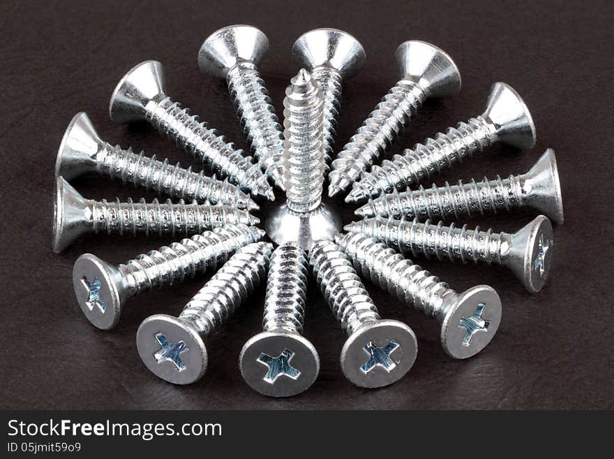 Screws on a dark background.