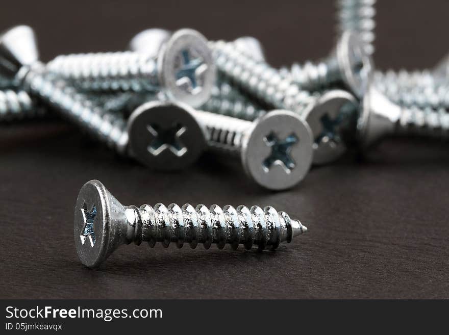 Screws on a dark background.