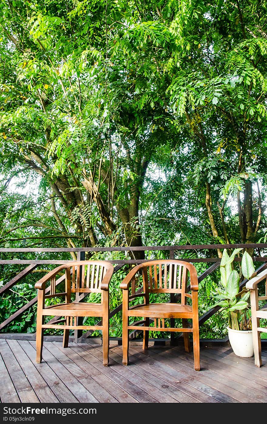 2 wodden chairs in a jungle resort