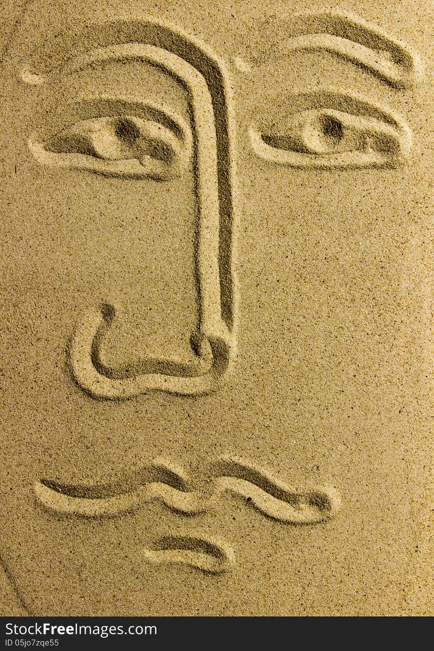 Draw face on sand