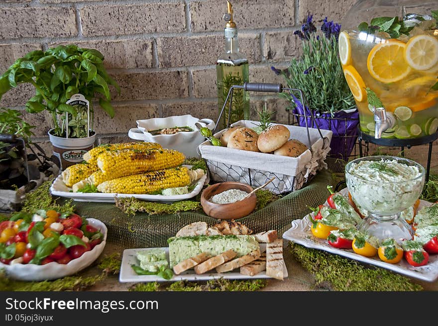 This is a food spread that focused on herbs. With herb butter, corn with herb salt, herb rolls, herb cream cheese. This is a food spread that focused on herbs. With herb butter, corn with herb salt, herb rolls, herb cream cheese