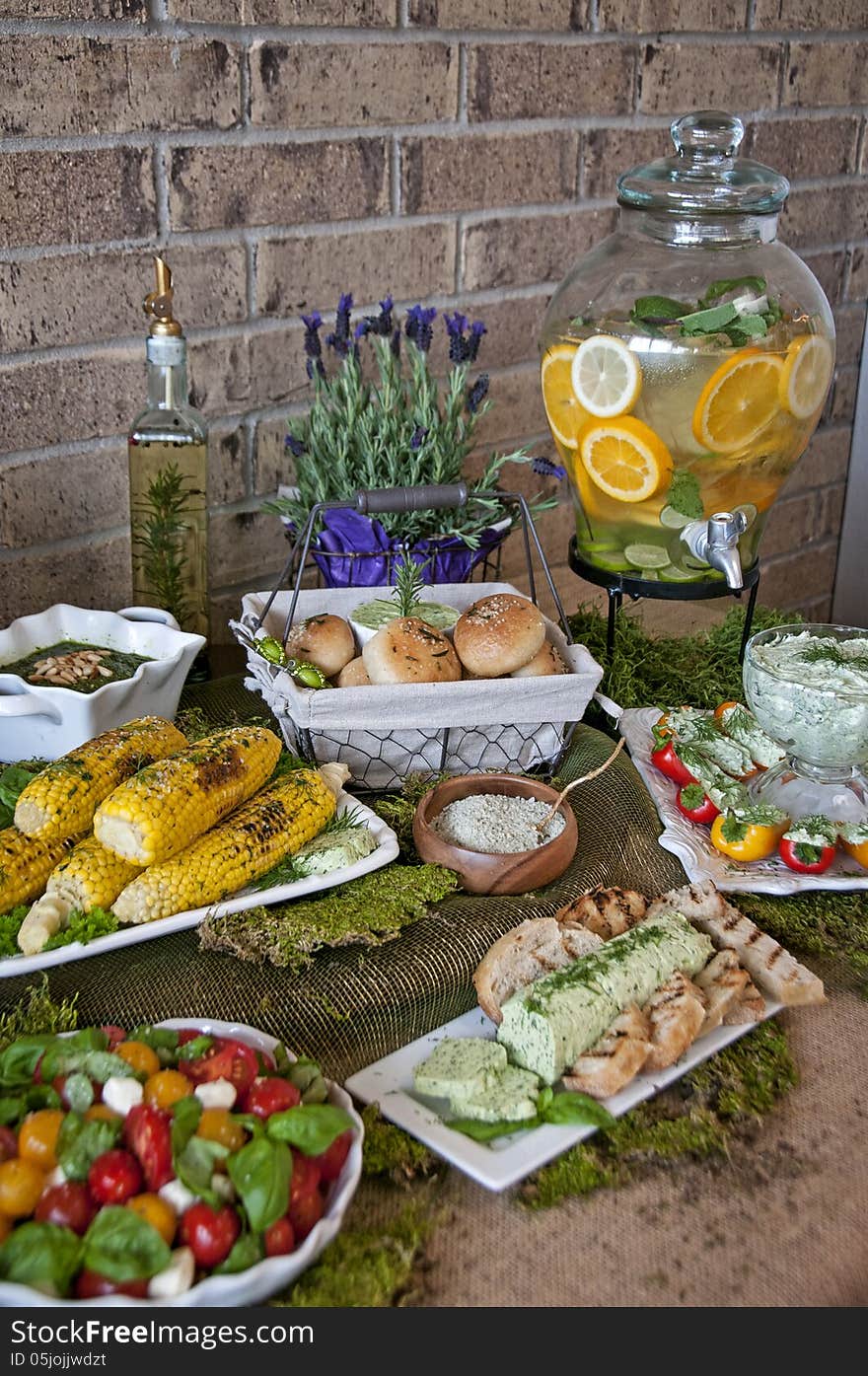 This is an herb spread, with caprese salad, herb butter, herb cream cheese, grilled corn and pesto