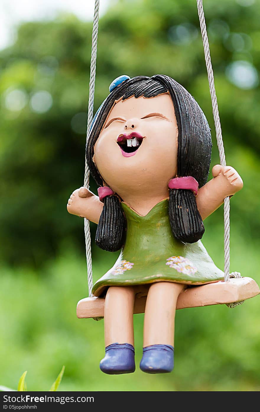 Clay doll girl on a swing. Clay doll girl on a swing.