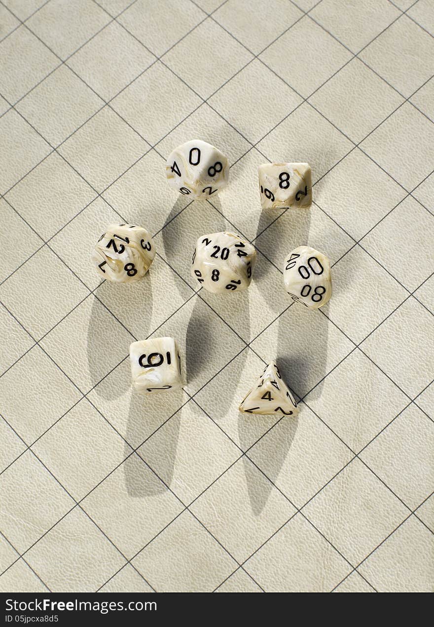 Polyhedral dice on blank roleplay game grid