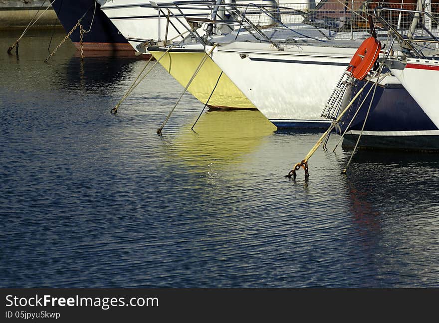 Colorful pleasure boats anchored in a seaport.