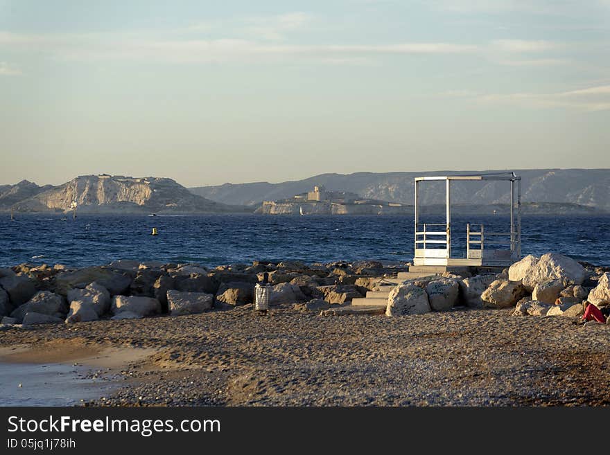 Beach along a rocky coastline. France, mediterranean coast. Beach along a rocky coastline. France, mediterranean coast.