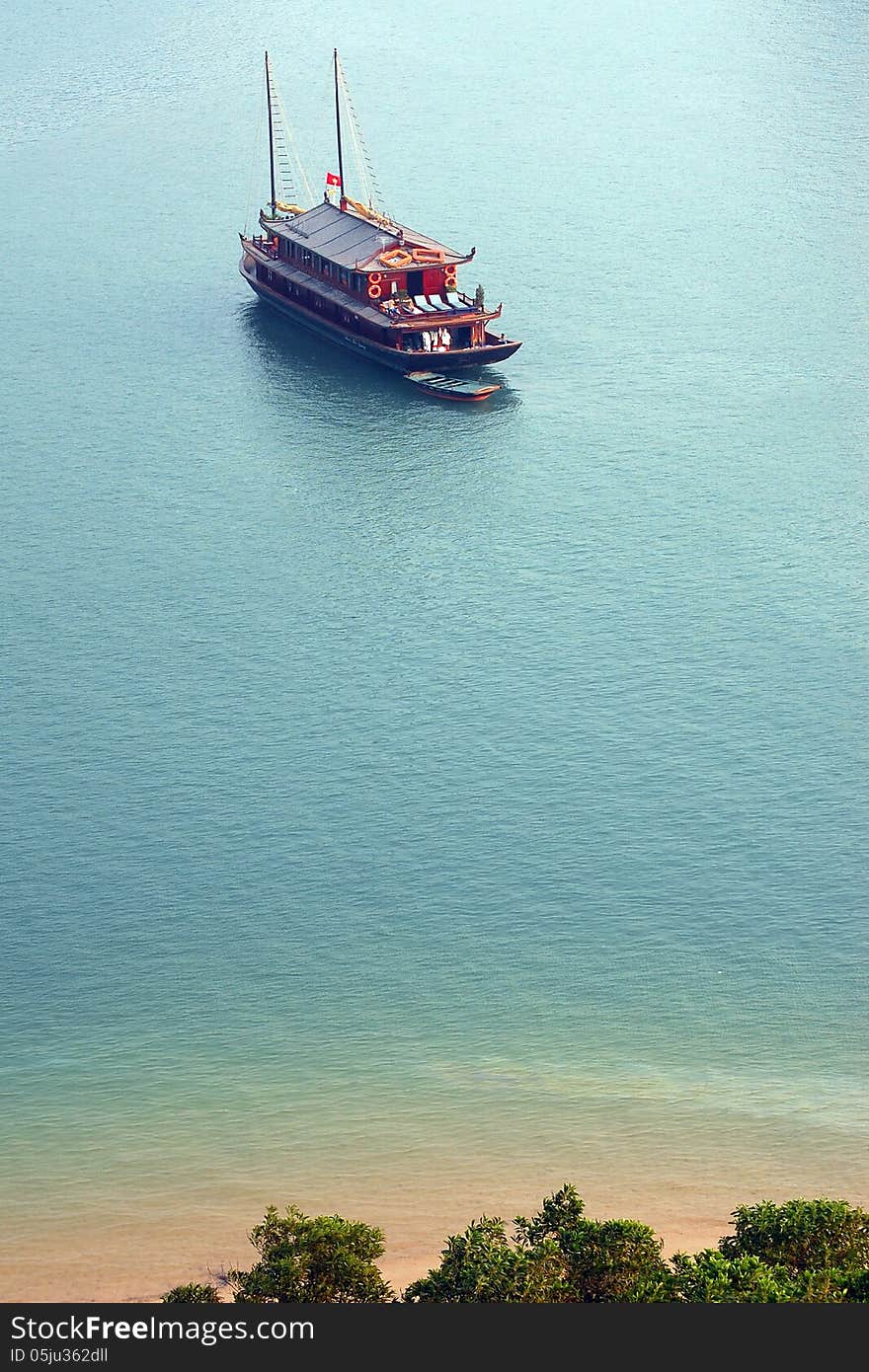 Ha Long Bay is a UNESCO world heritage site and a popular travel destination. Picture of cruise boat taken from top of an island mountain. Ha Long Bay is a UNESCO world heritage site and a popular travel destination. Picture of cruise boat taken from top of an island mountain.