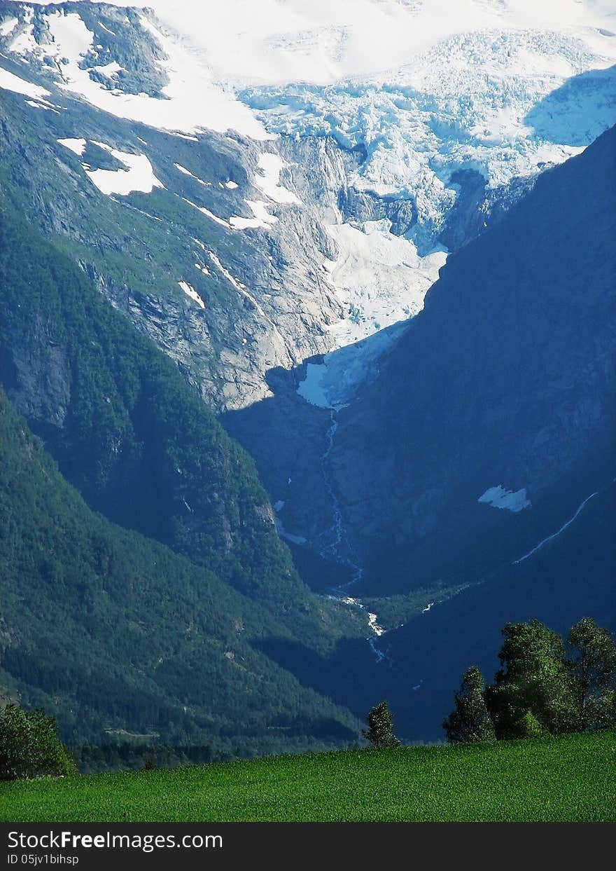 Landscape with a view of the and forest vegetation cloud lake glacier in the Norwegian mountains flows down the river. Landscape with a view of the and forest vegetation cloud lake glacier in the Norwegian mountains flows down the river