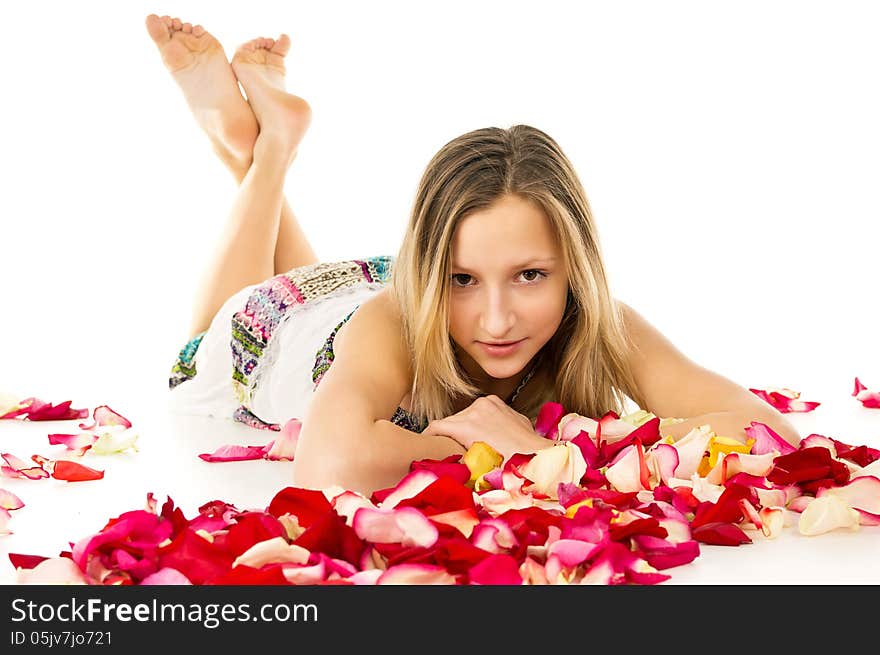 Healthy skin, a beautiful girl lies in rose petals