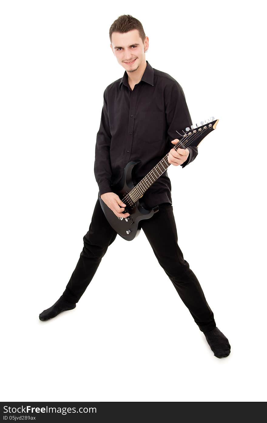 Guy in black clothes plays the guitar isolated on white background