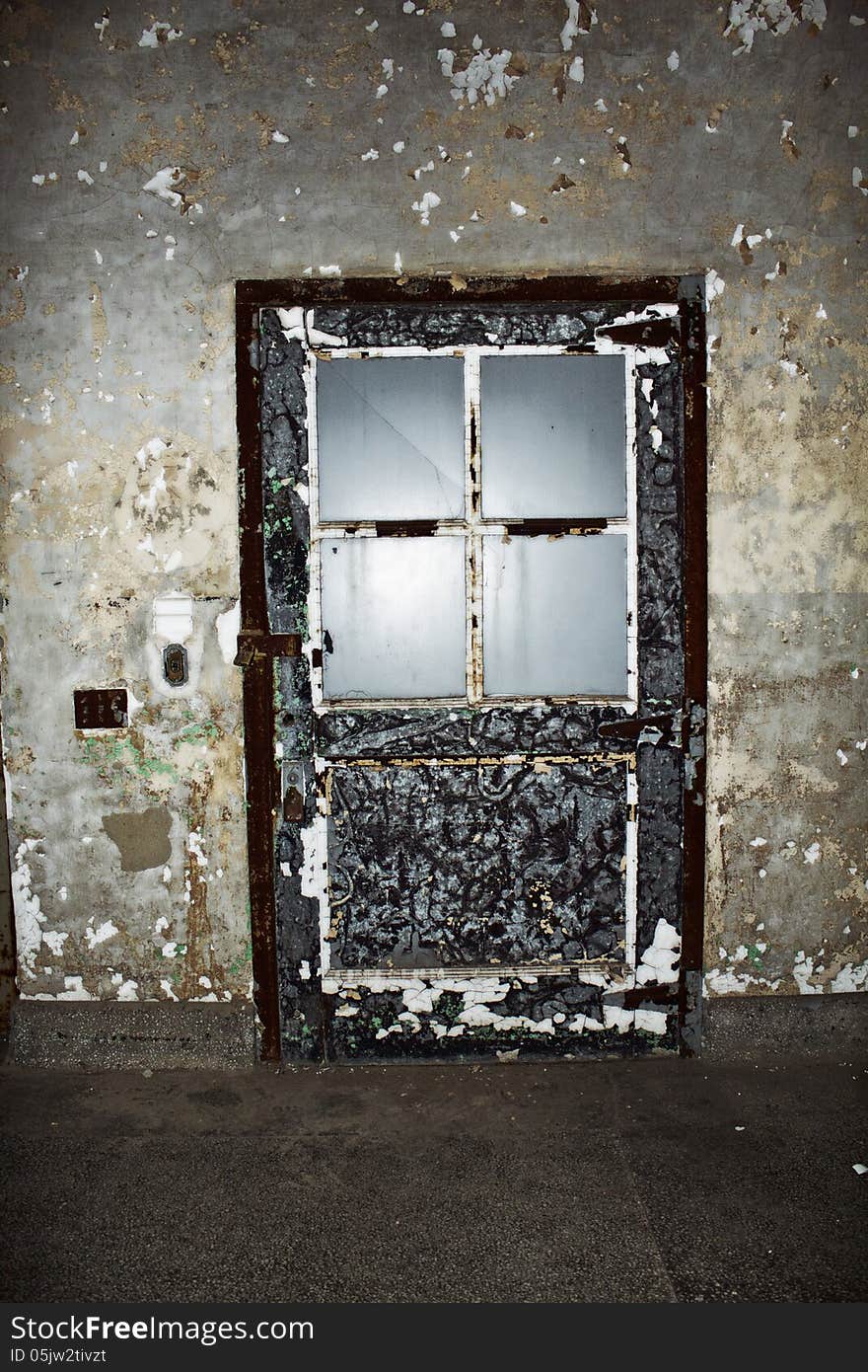 Blue door with cracked and peeling paint in an abandoned building. Blue door with cracked and peeling paint in an abandoned building