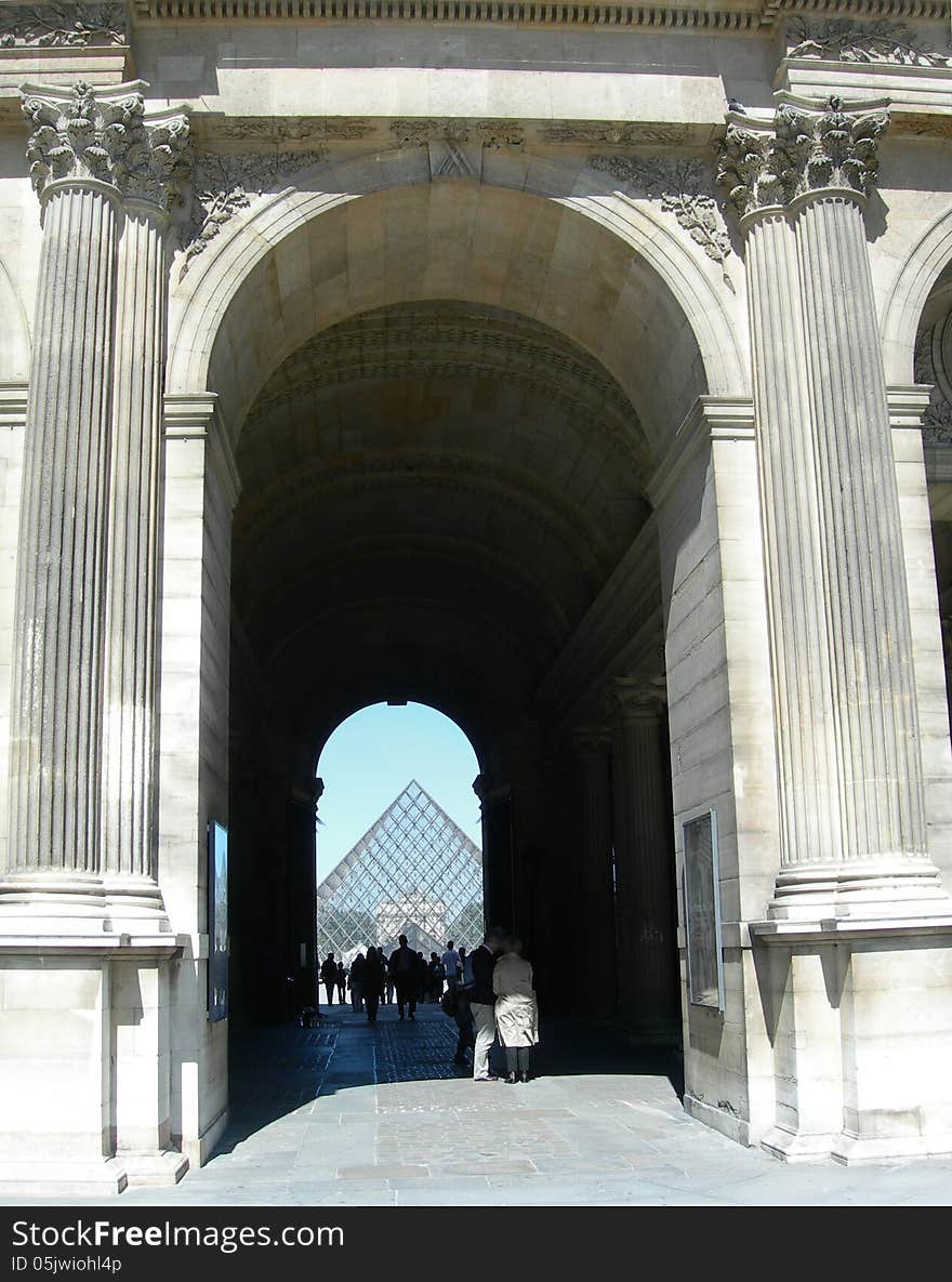 Detail architecture of passage to the interior court and glass structure of the Louvre museum in Paris, France