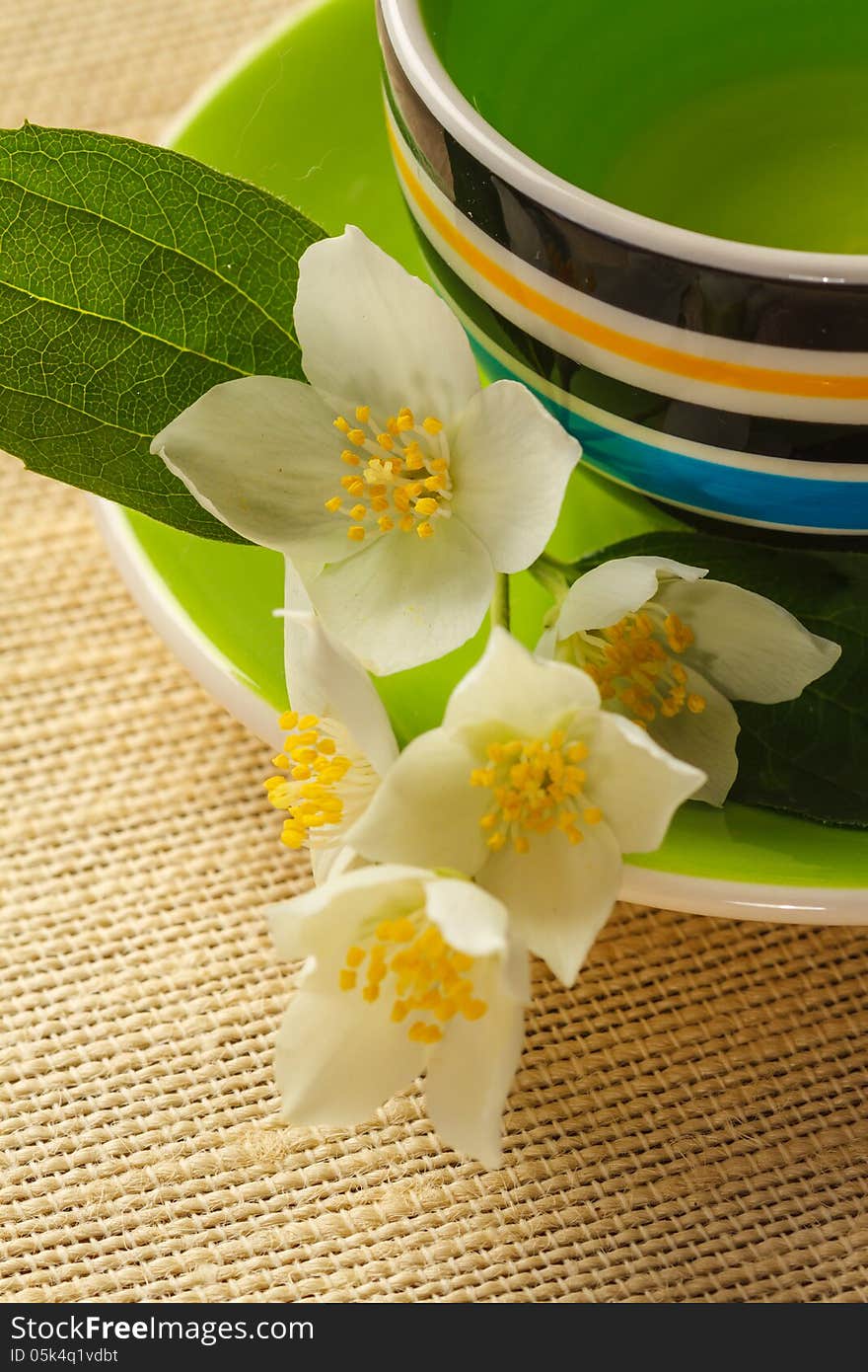 Cup of jasmine tea and jasmine flowers