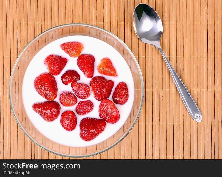 Strawberry with milk in a glass plate. Strawberry with milk in a glass plate