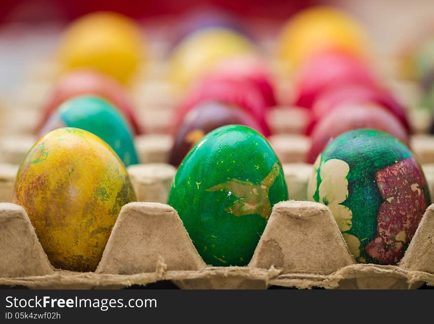 Easter eggs in various colors placed in row.