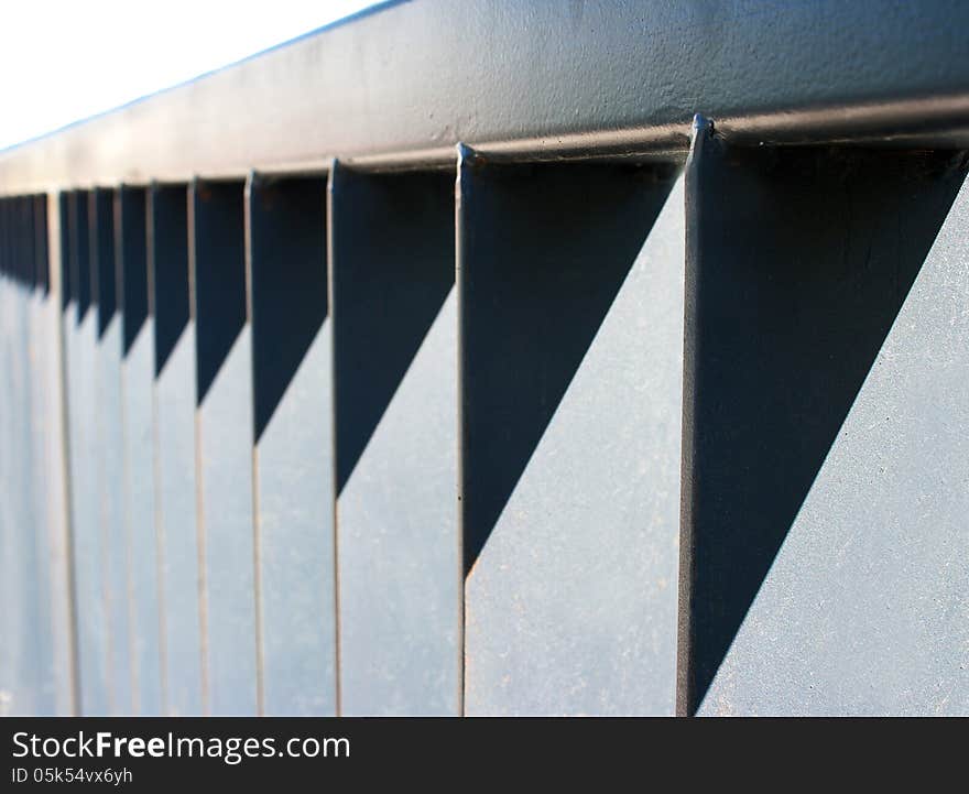 Detail of section of metal fencing on sunny light